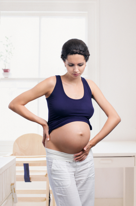 http://www.dreamstime.com/stock-image-pregnant-woman-stomach-pain-young-home-image30593651