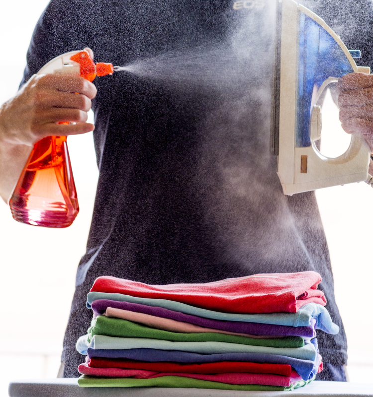 http://www.dreamstime.com/royalty-free-stock-image-spray-steam-iron-man-spraying-water-against-hot-over-pile-colourful-clothes-creating-clouds-image35195966