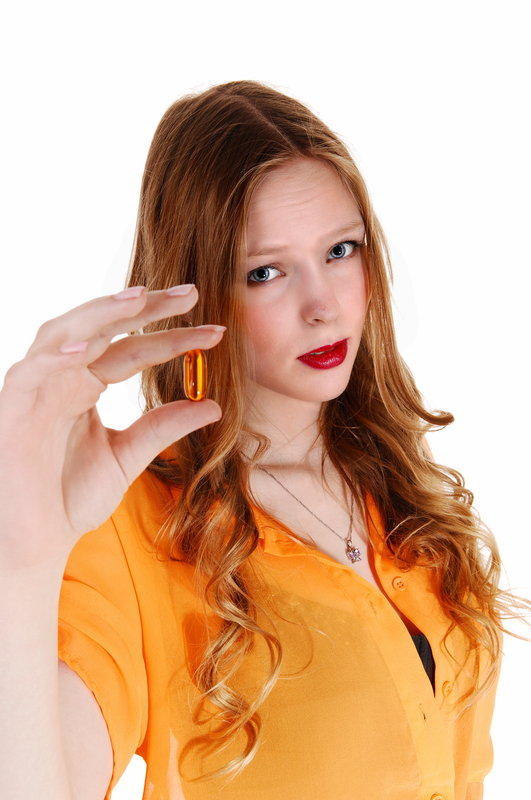 http://www.dreamstime.com/stock-photos-girl-showing-vitamin-pill-serious-looking-young-woman-yellow-blouse-big-capsule-looking-sceptical-isolated-white-image40199353