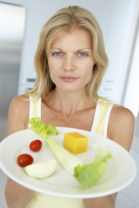 http://www.dreamstime.com/royalty-free-stock-photography-mid-adult-woman-holding-plate-healthy-food-image7873467