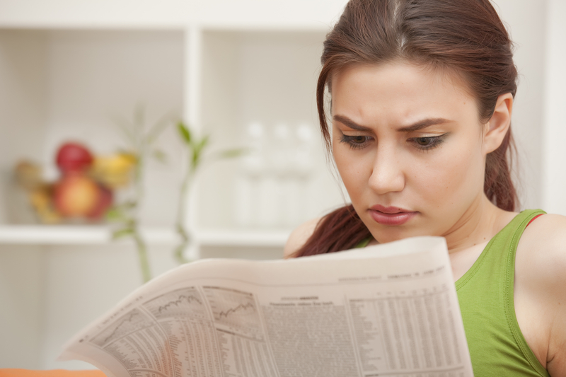 http://www.dreamstime.com/royalty-free-stock-image-woman-reading-bad-news-newspaper-image19976426