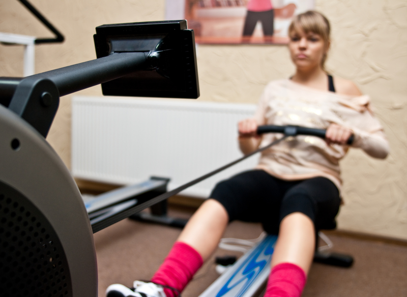 http://www.dreamstime.com/stock-photo-woman-using-rowing-machine-young-gym-image36018960