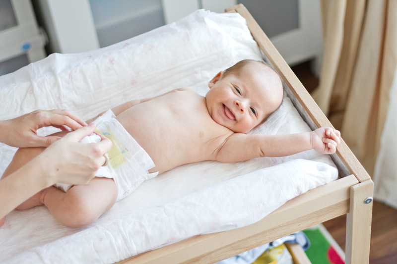 http://www.dreamstime.com/stock-photos-happy-baby-his-diapers-being-changed-his-room-changing-table-image33489783
