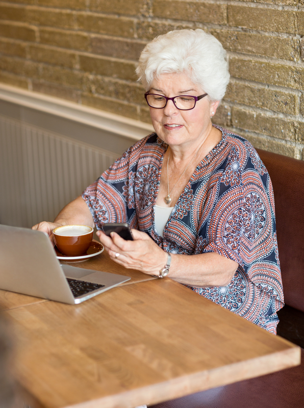 http://www.dreamstime.com/royalty-free-stock-image-woman-text-messaging-smartphone-cafe-senior-laptop-coffee-cup-image35691096