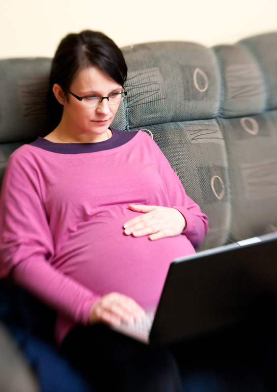 http://www.dreamstime.com/royalty-free-stock-photo-pregnant-woman-laptop-bed-image13381235