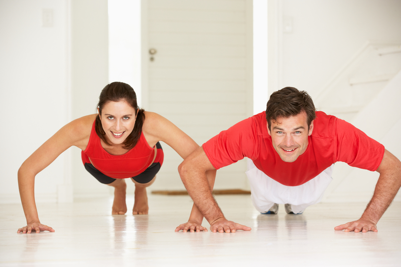 http://www.dreamstime.com/royalty-free-stock-photo-couple-doing-push-ups-home-gym-image21049185