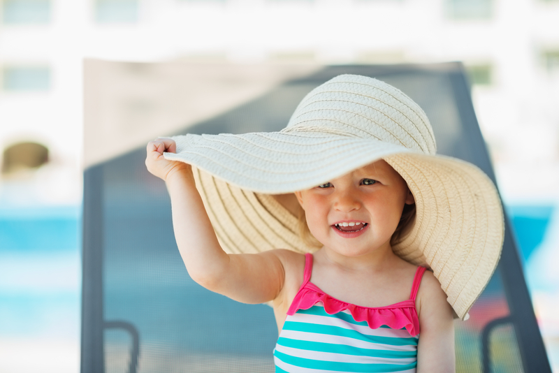 http://www.dreamstime.com/royalty-free-stock-images-baby-beach-hat-sitting-sun-bed-image25730999