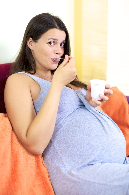 http://www.dreamstime.com/stock-photos-happy-pregnant-woman-eating-yogurt-home-image27999283