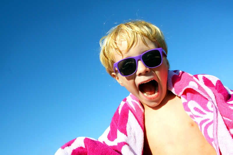 http://www.dreamstime.com/royalty-free-stock-photo-hip-excited-child-beach-towel-sunglasses-young-boy-has-big-smile-his-face-as-stands-outside-wrapped-bright-pink-image33921755