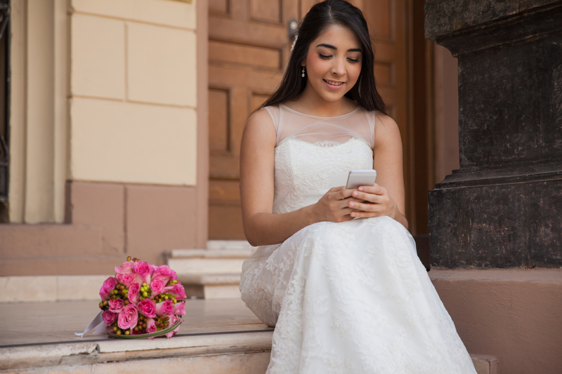 http://www.dreamstime.com/royalty-free-stock-photos-social-networking-my-wedding-cute-bride-texting-her-cell-phone-her-day-image42050518