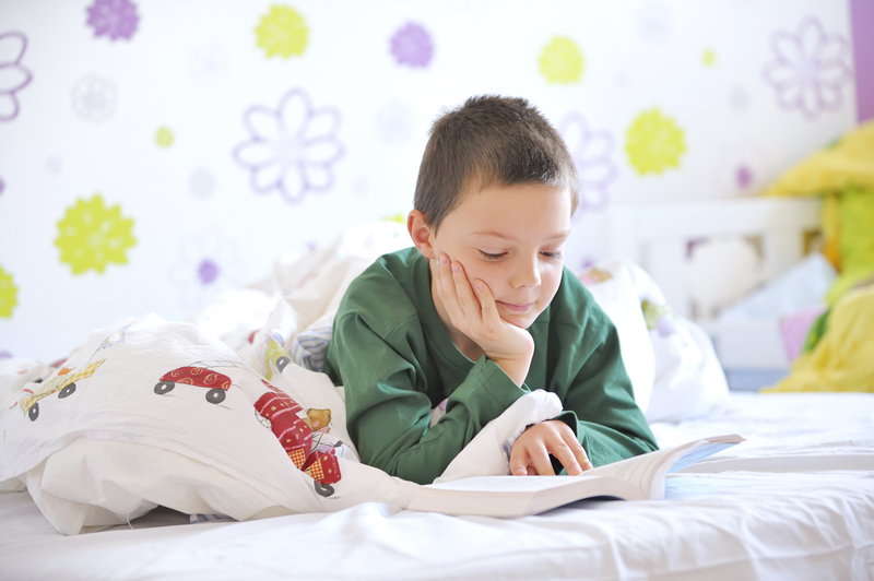 http://www.dreamstime.com/stock-photos-young-boy-his-bed-reading-book-image22310543