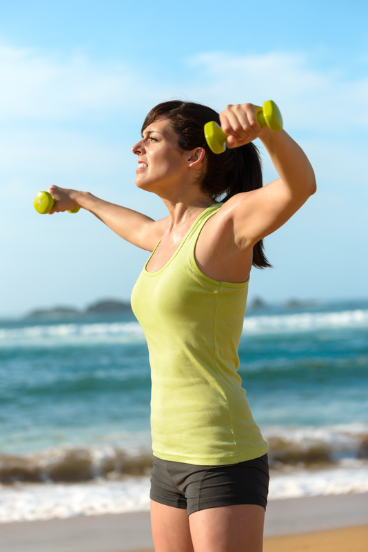 http://www.dreamstime.com/royalty-free-stock-photography-fitness-woman-work-out-beach-training-shoulders-dumbbells-summer-exercising-weights-outdoor-caucasian-sport-girl-image30831767